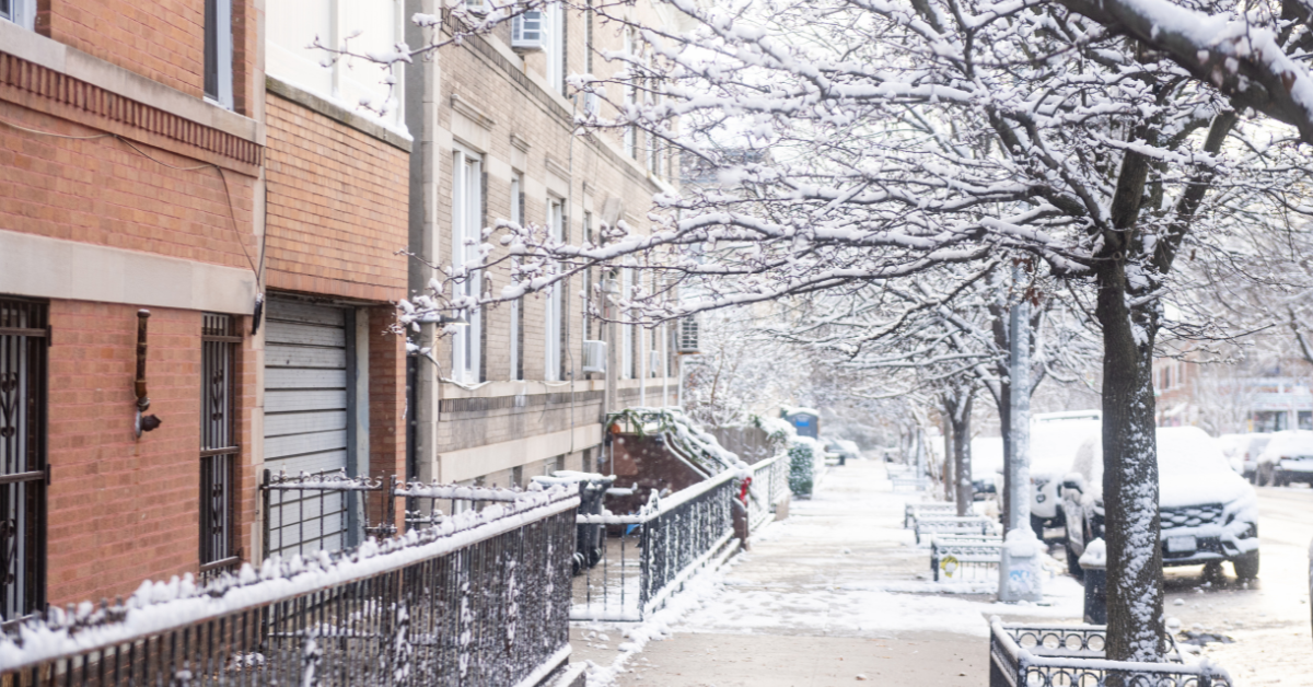 Wintery street in Brooklyn, New York with a row of brownstones and snow