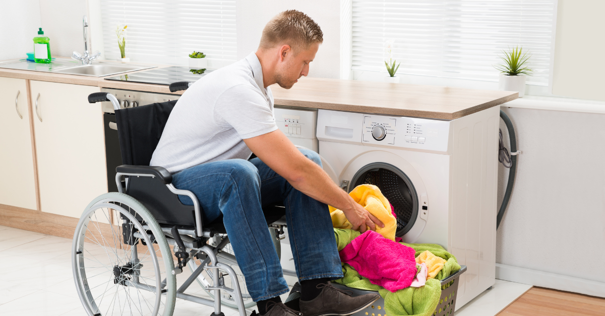 Man grabbing laundry to do from his wheelchair