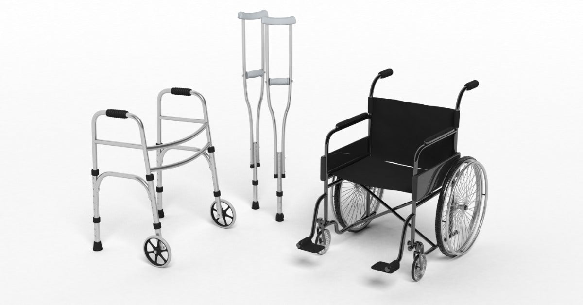 A collection of mobility aids against a white background. There is a wheelchair, a walker, and a pair of crutches.