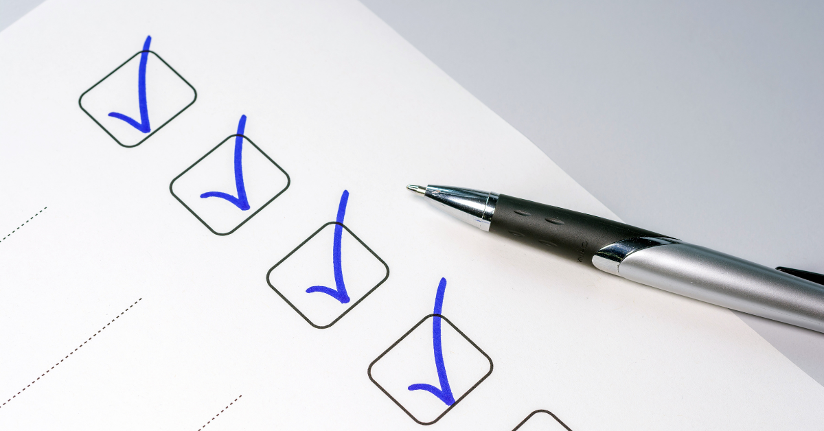 Paper with boxes checked off in blue ink and pen on it
