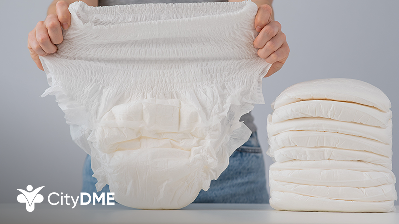 Person holding absorbent adult diaper in their hands