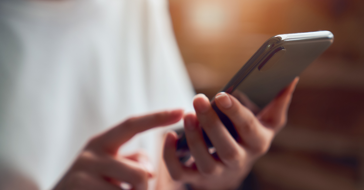 Person holding smartphone with finger ready to tap on the screen