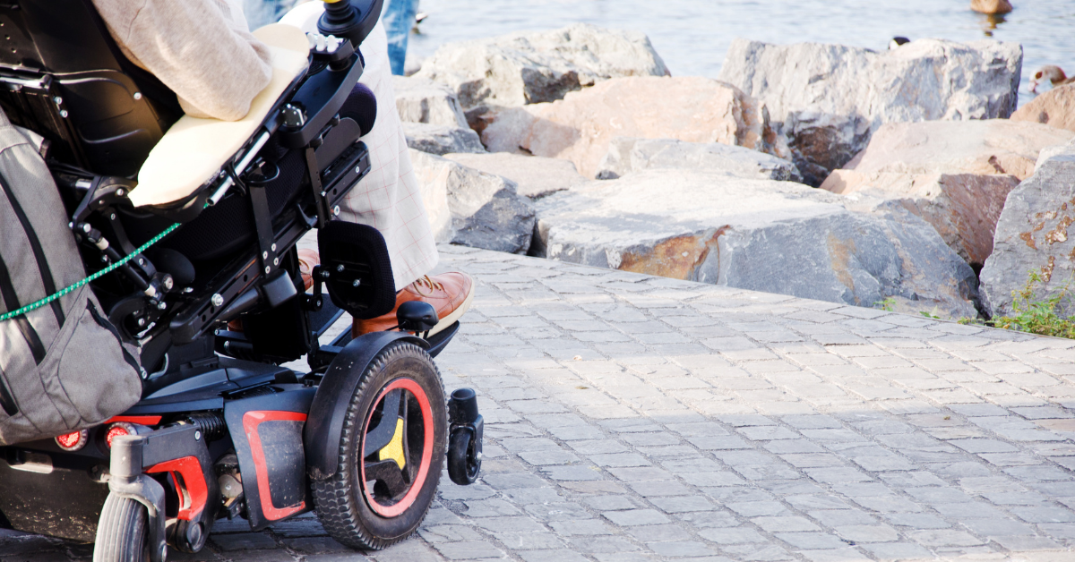 Person sitting in power wheelchair looking out on nature