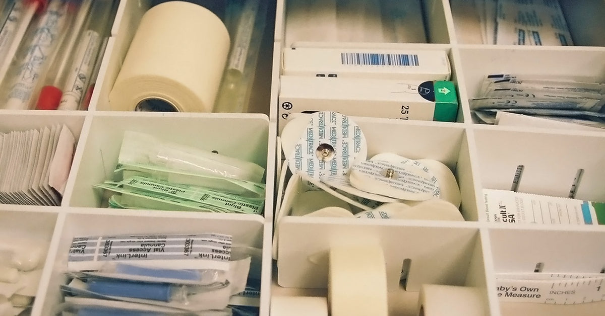 A medical supply drawer with multiple compartments for different medical supplies like gauze and bandages.